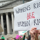 protestors outside the US Supreme Court holding a sign that says "Women's rights are human rights"